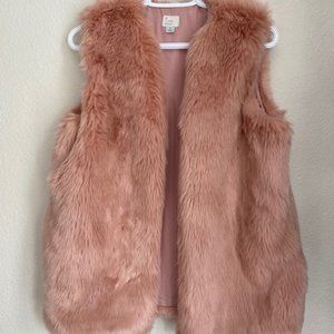 A blush pink faux fur vest with pockets